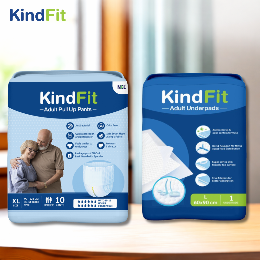 
front View Two packages of KindFit adult care products on a wooden surface with a blurred background.

