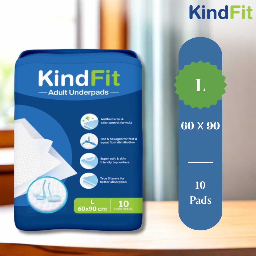 KindFit adult underpads packaging on a wooden surface with a blurred background

