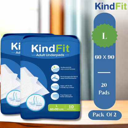 Two packages of KindFit adult underpads with packaging details on a wooden surface.

